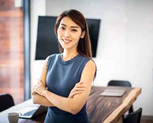 Confident Asian businesswoman in office.